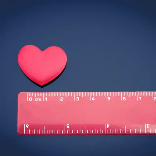 A red love heart next to a red ruler