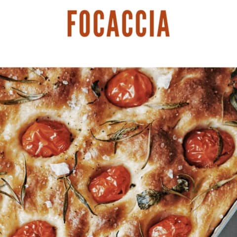 A Italian bread foccacia with tomatoes and herbs.from a loaf of fresh Focaccia Bread.