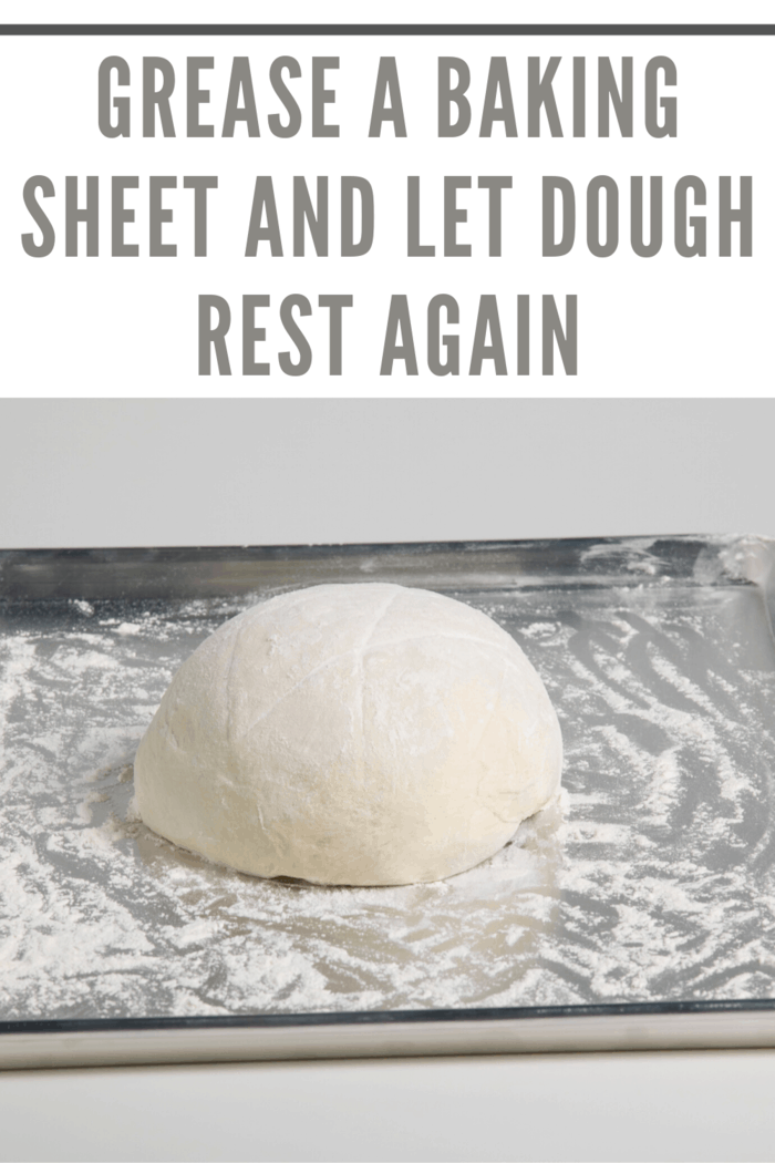 bread resting on greased baking sheet