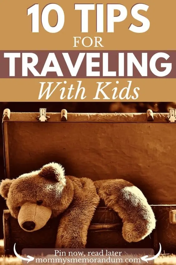 A brown stuffed bear nestled in a suitcase, representing family travel and packing essentials for kids.