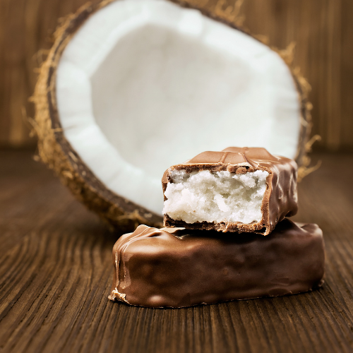 chocolate bar with coconut filling with open coconut in background.