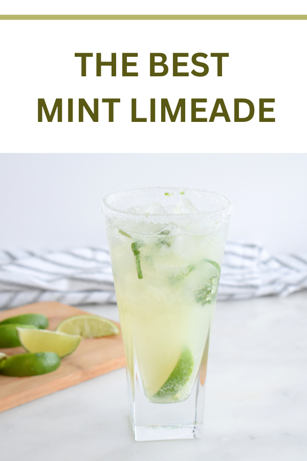 Glass of refreshing mint limeade with fresh lime slices and mint leaves, a perfect summer drink.