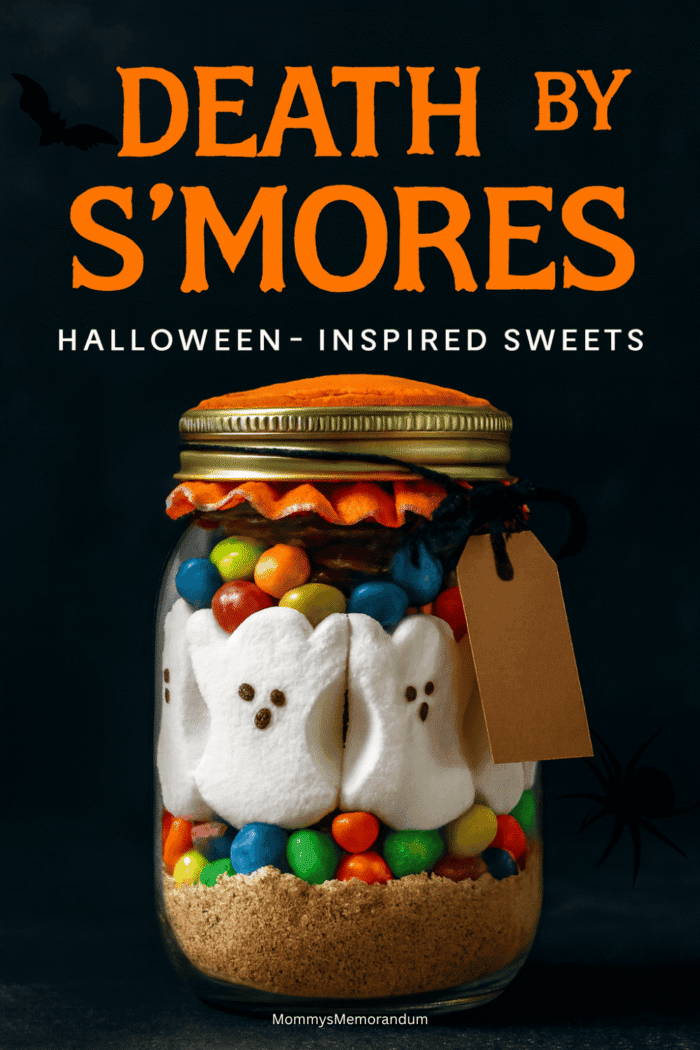 Halloween S’mores in a Jar with ghost Peeps, M&Ms, and graham cracker crumbs layered in a mason jar with orange fabric lid and spooky tag.