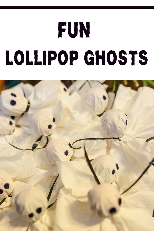 DIY spooky Tootsie Pop Ghosts with white kleenex and black marker for Halloween party treats.