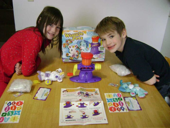 The kiddos with the contents of the Wuggle Pets Starter Kit