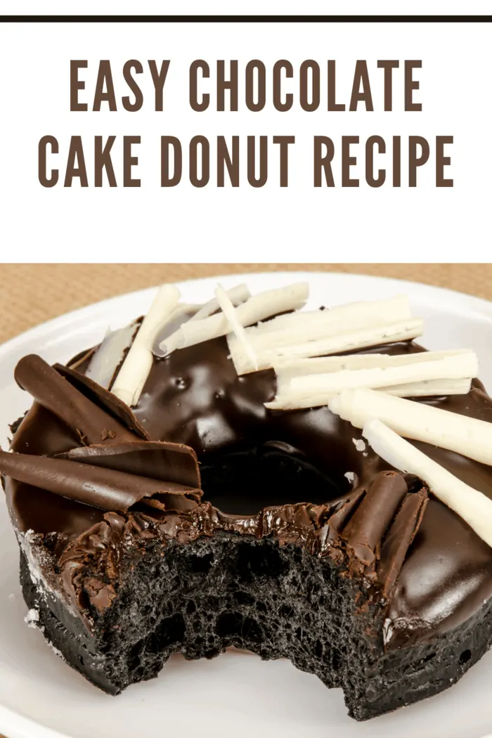 chocolate cake donut embellished with white chocolate curls with bite taken