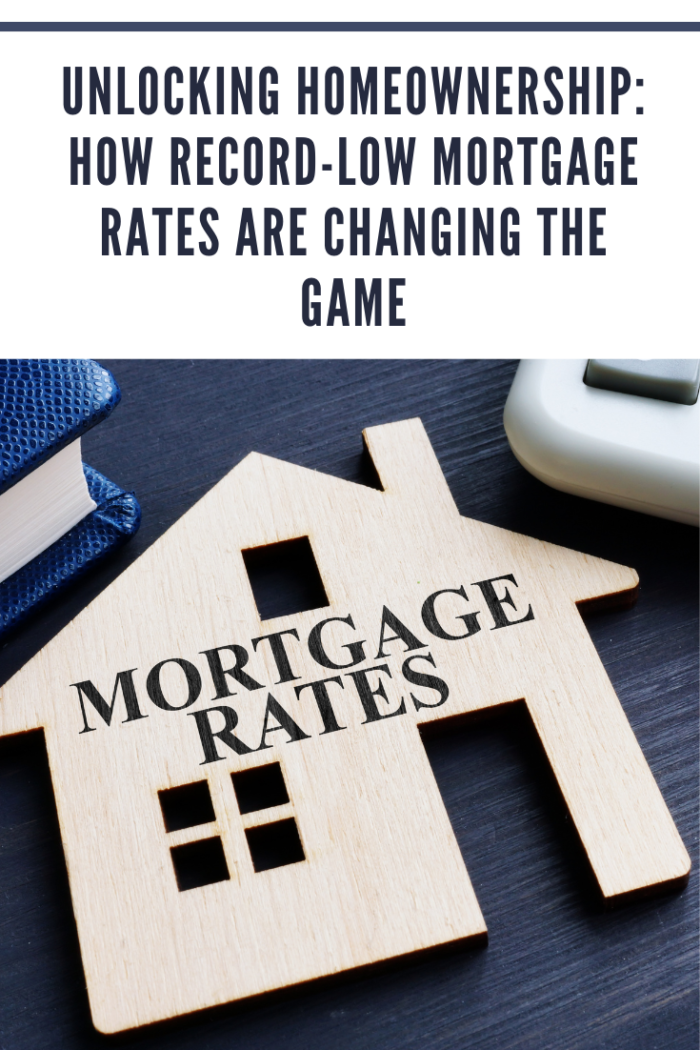 Mortgage rates written on a wooden model of house.