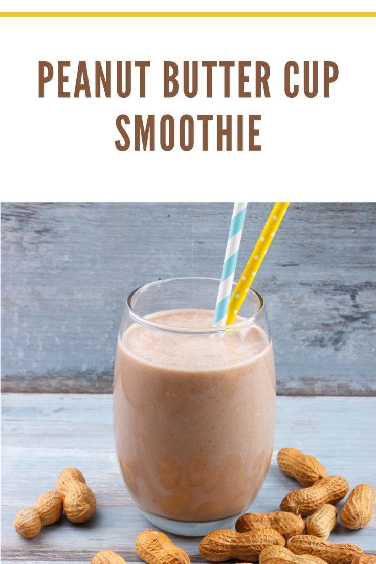 peanut butter cup smoothie with 2 straws and peanuts in shells around glass.