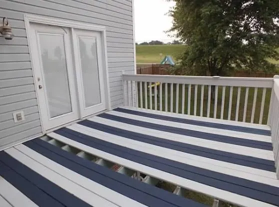 Deck painted in navy blue and white stripes with HGTV Home Exterior Paint for decks by Sherwin Williams