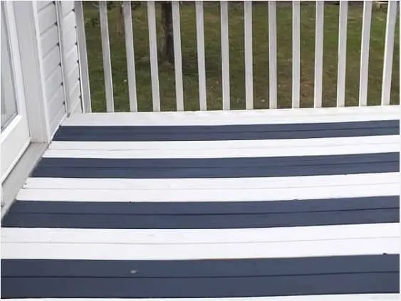 Deck painted in navy blue and white stripes with HGTV Home Exterior Paint by Sherwin Williams