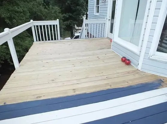 Deck painted with Sherwin Williams HGTV Home Exterior Paint in navy blue and white stripes