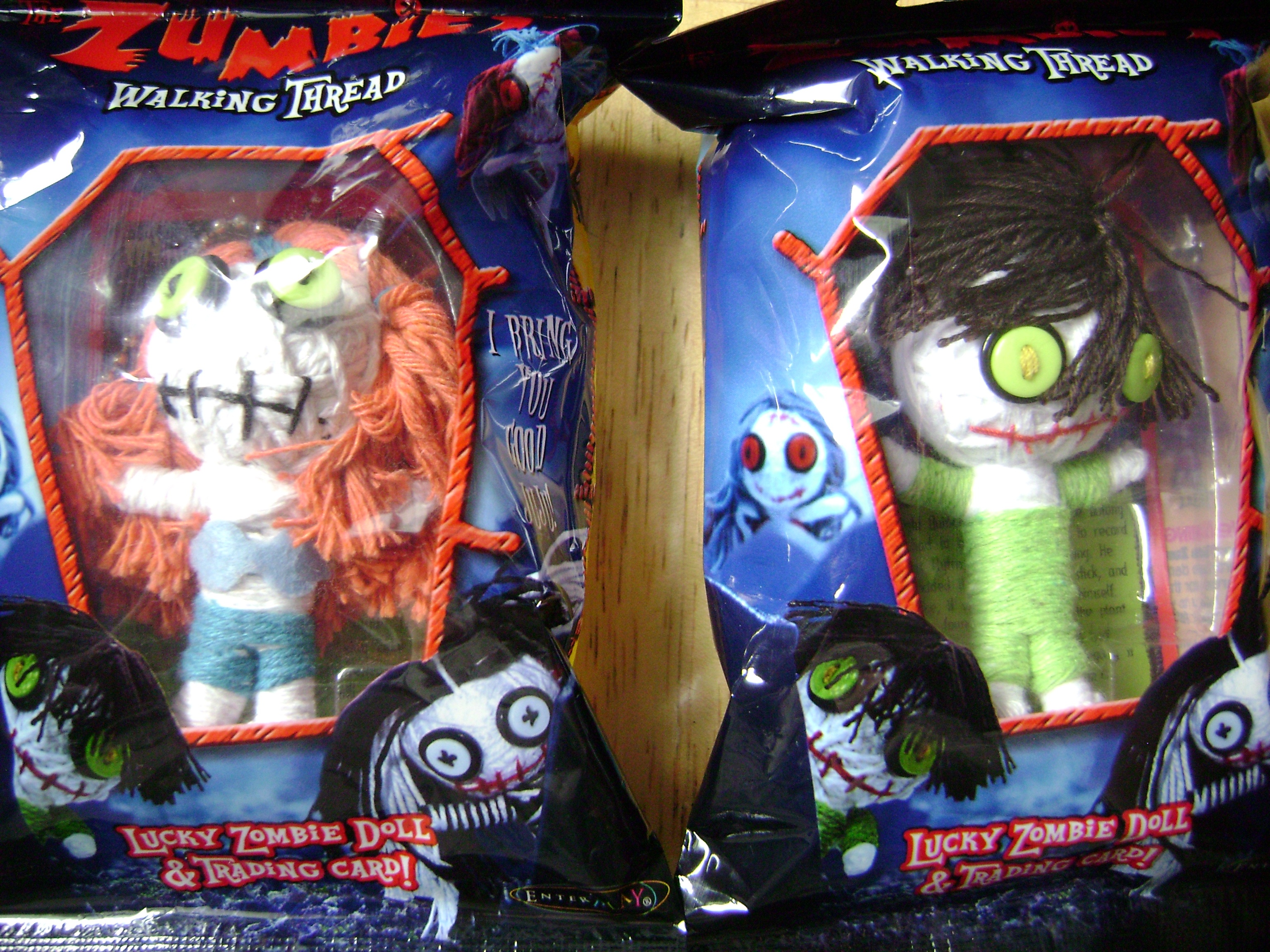 Two Zumbies: The Walking Thread toy packs featuring adorable zombie dolls with vibrant hair and googly eyes, each including a trading card.