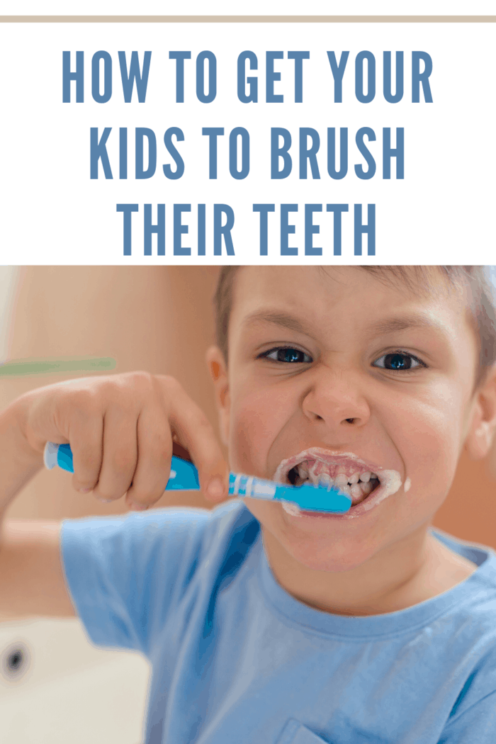 small boy in blue shirt brushing teeth