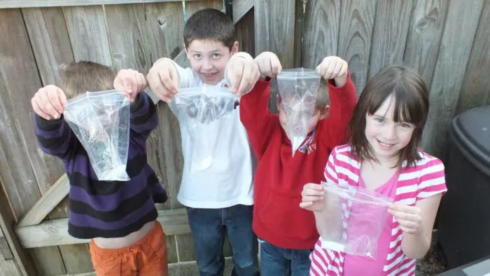 Kids holding Borax bouncy balls ingredients in a Ziploc bag, showcasing DIY craft materials