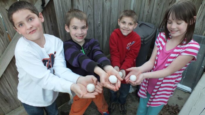 Kids holding vibrant Borax bouncy balls, showcasing a fun DIY craft project with bright colors