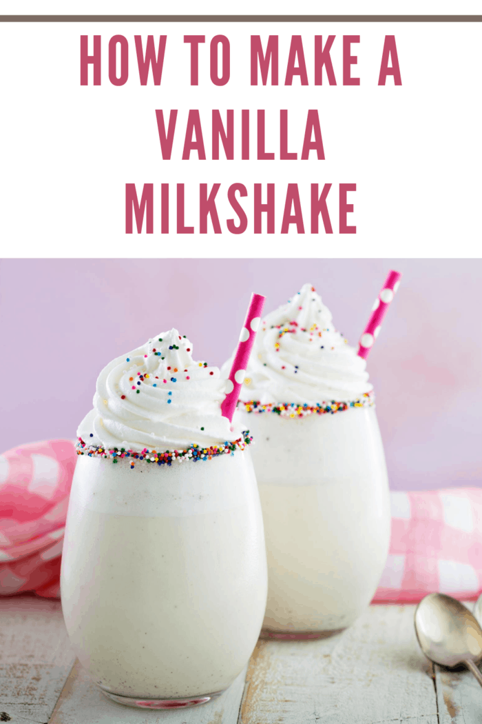 Two easy vanilla milkshakes with whipped cream, colorful sprinkles, and straws in rimmed glasses