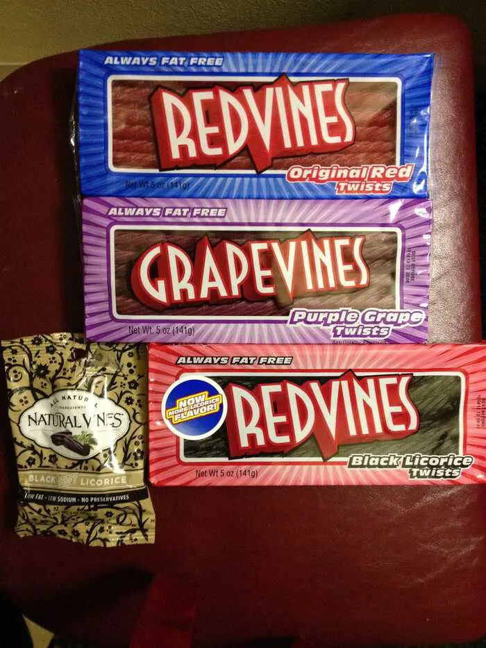 A selection of licorice packages including Red Vines Original Red, GrapeVines Purple Grape Twists, and Naturally Vines Black Licorice.