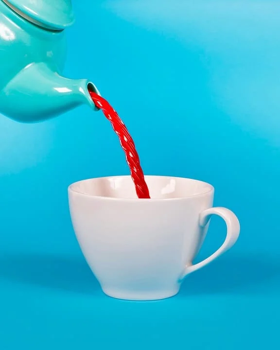 licorice being poured out of tea pot into cup