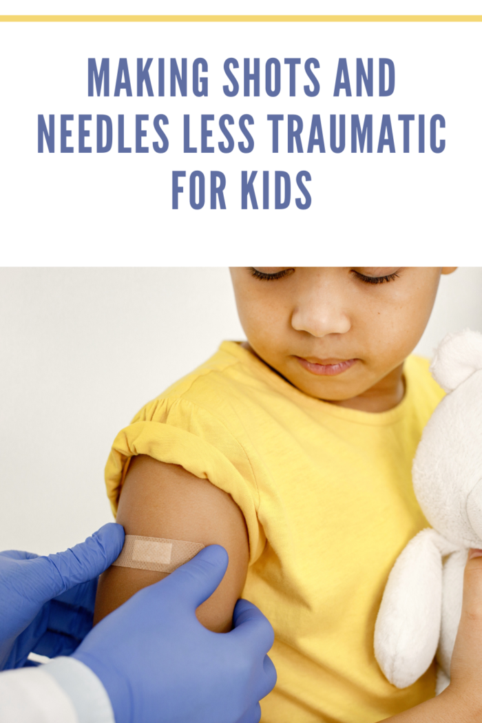 Doctor Putting Band-Aid on the Arm of Girl After Vaccine