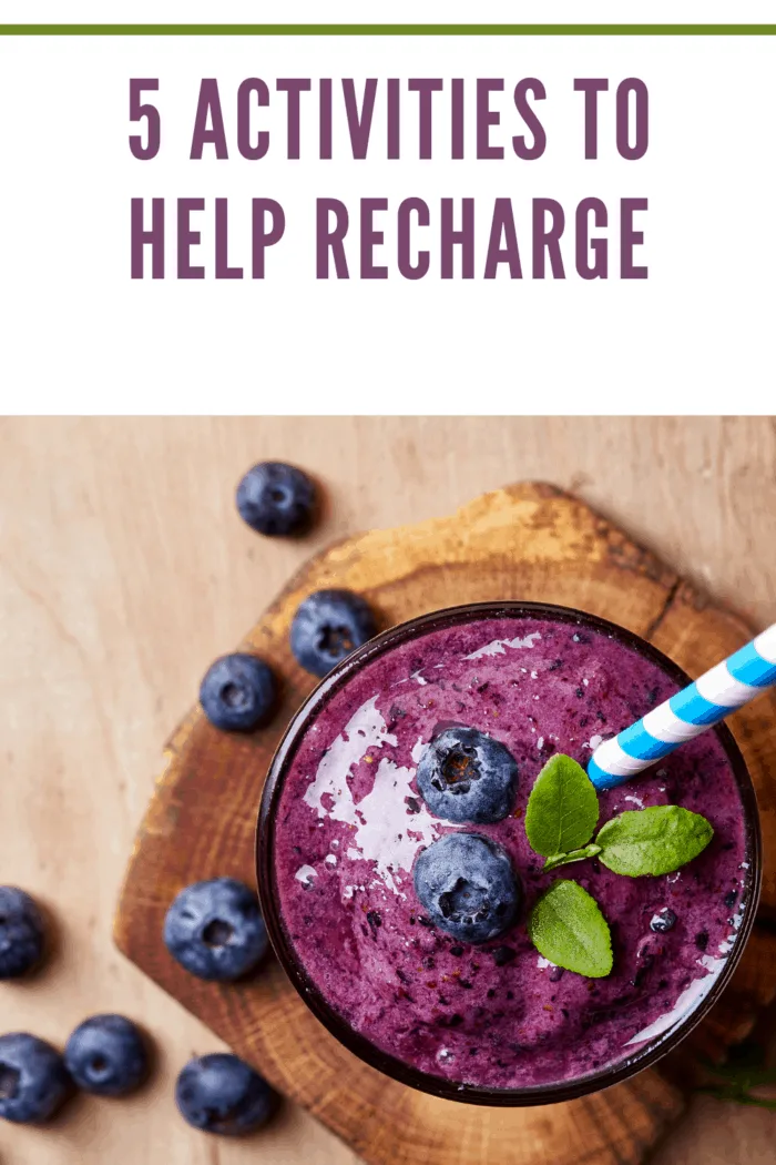 Glass of blueberry smoothie on wooden background from top view