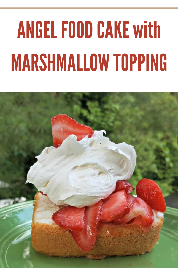 Fluffy angel food cake topped with marshmallow creme and strawberries, a light summer dessert.