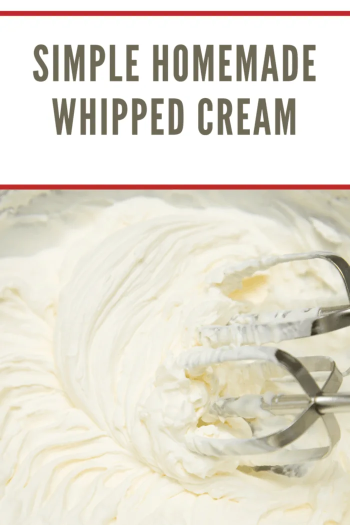 Close-up of freshly whipped cream with a hand mixer in the cream.