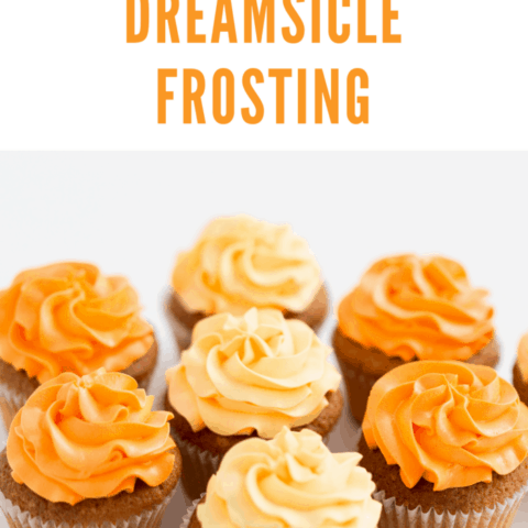 food, pastry and confectionery concept - cupcakes with orange dreamsicle buttercream frosting over white background