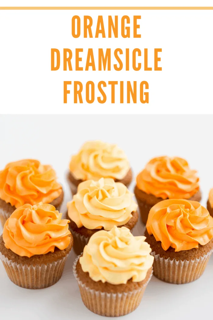 food, pastry and confectionery concept - cupcakes with orange dreamsicle buttercream frosting over white background