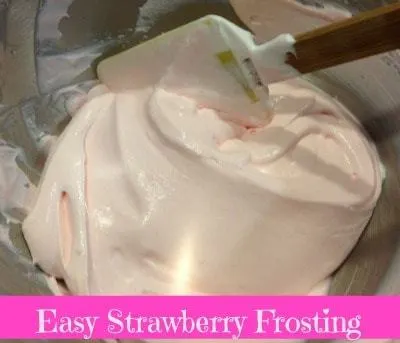 Bowl of smooth and fluffy easy 3-ingredient strawberry frosting with a spatula.