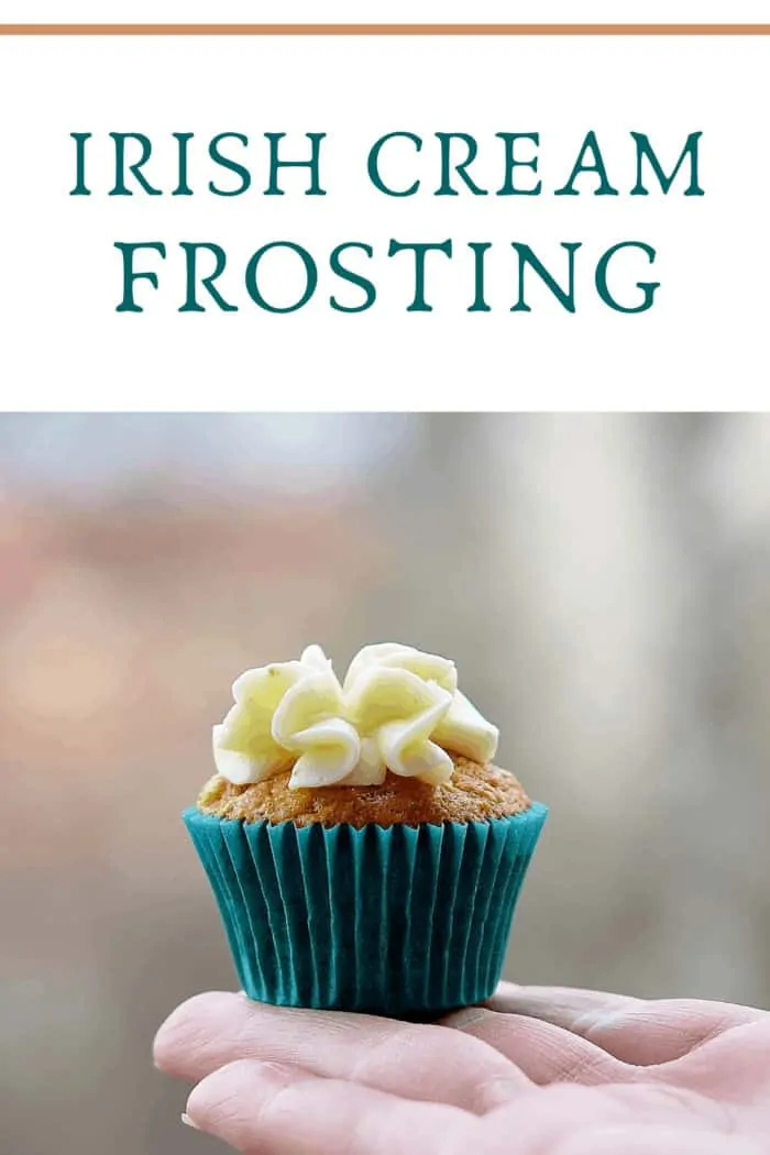 Hand Holding Cupcake Outdoors. Cupcake topped with irish cream frosting