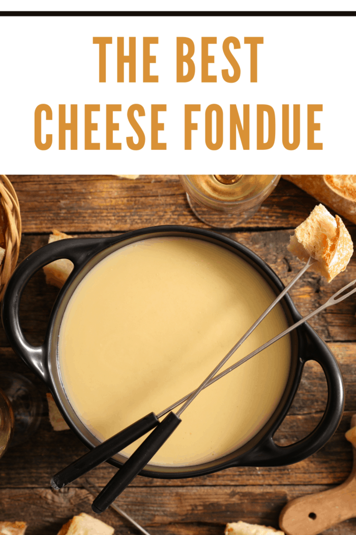 cheese fondue in pot with fondue forks resting on pot