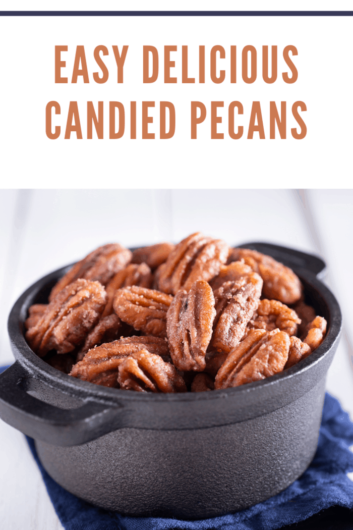 close up of candied pecans in black bowl
