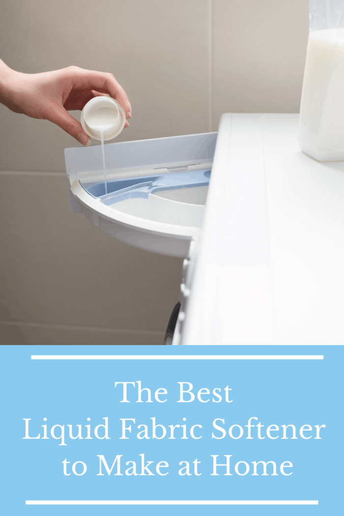 A person pouring homemade liquid fabric softener into a washing machine drawer with a jug of softener beside it.