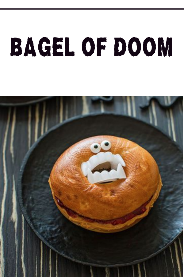 A Halloween-themed bagel with plastic fangs and candy eyes, a spooky and fun PB&J snack for kids