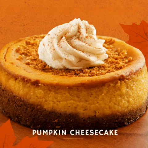 Whole pumpkin cheesecake topped with whipped cream and ginger snap crumbs, set against a warm orange background with autumn leaves and the text &ldquo;Crust Fall in Love.&rdquo;