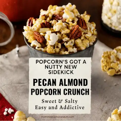 Close-up of caramel-coated popcorn mix with pecans and almonds in a rustic tin, styled with cozy textures and warm lighting.