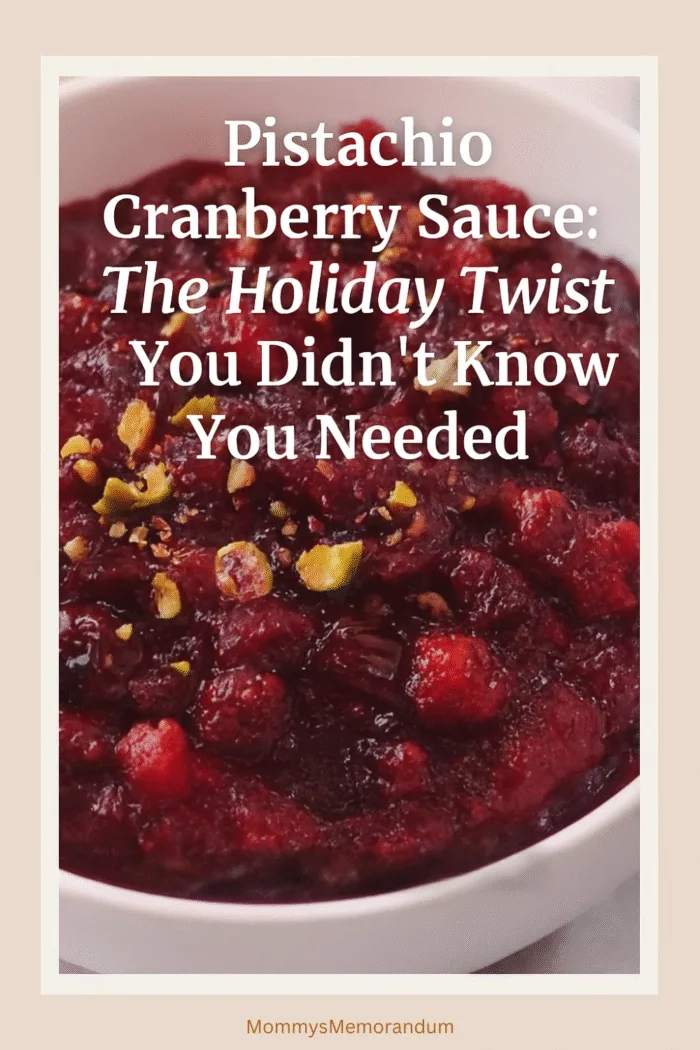 Bowl of pistachio cranberry sauce topped with chopped pistachios and lemon zest, styled with warm holiday decor