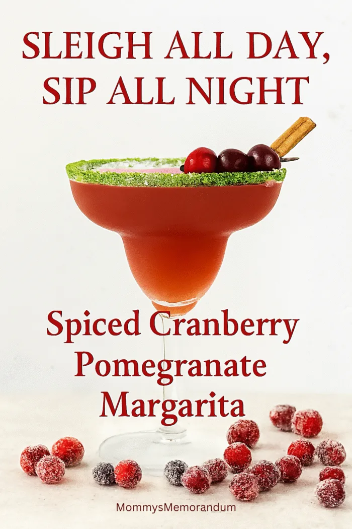 Festive margarita in a sugar-rimmed glass garnished with cranberries and cinnamon stick, surrounded by sugared cranberries