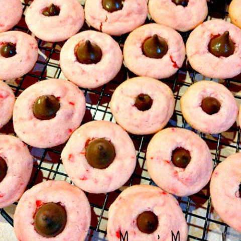 Moonshine Cherry Blossoms cookies topped with Hershey's Kisses, featuring a sweet, boozy twist.