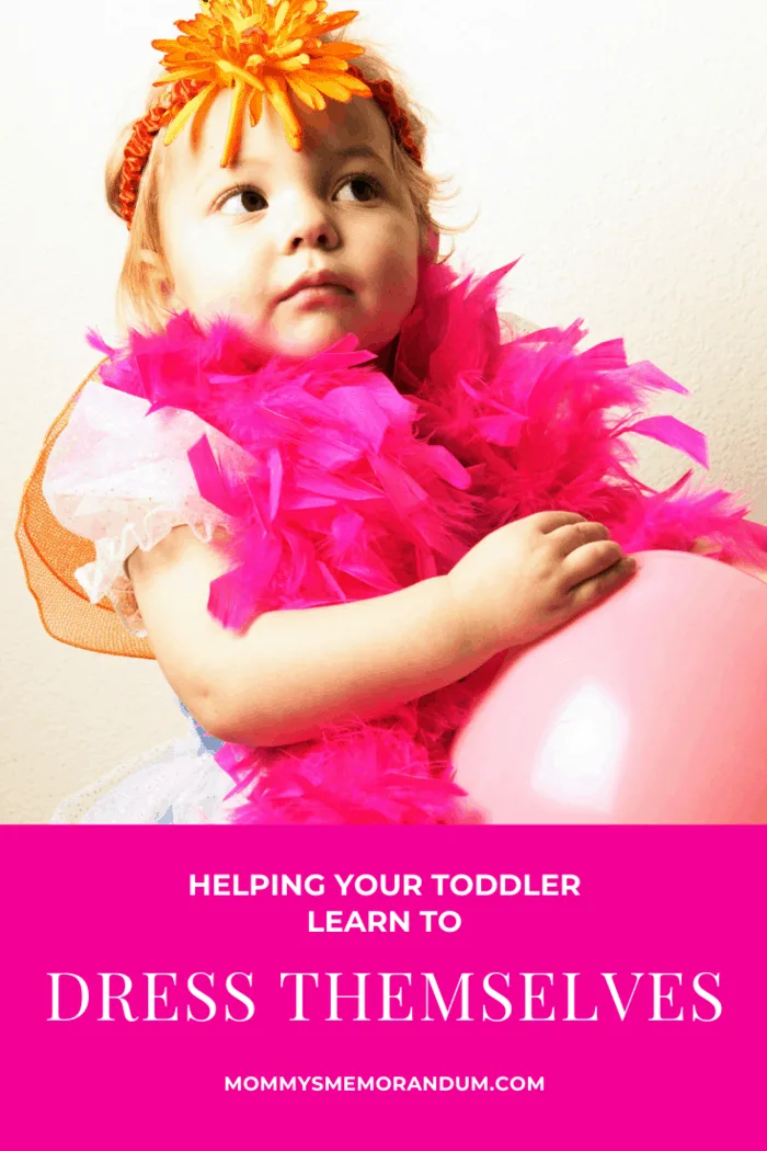 Toddler who is learning to dress herself in feather boa