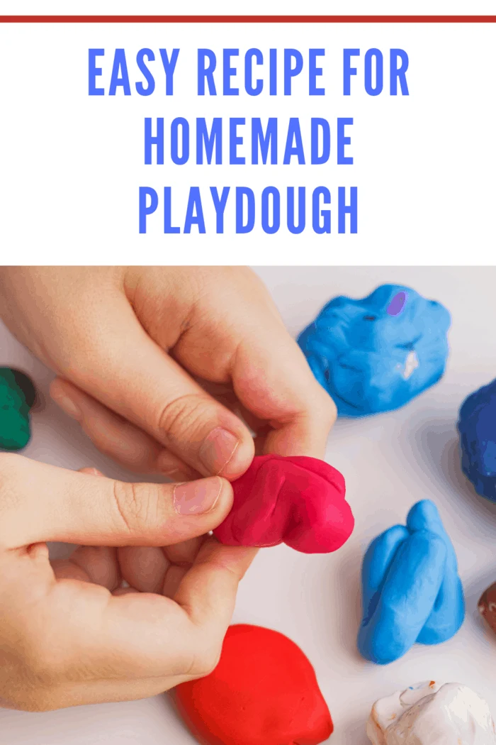 Child playing with homemade playdough with essential oils and making a giftbox. Close up.