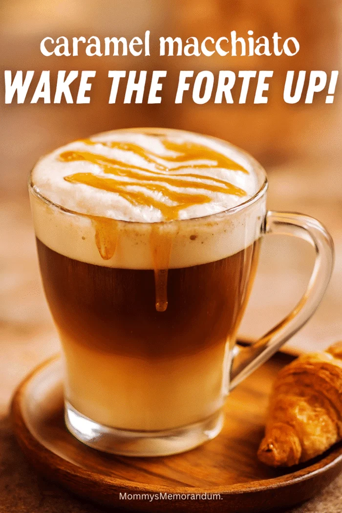 A cozy caramel macchiato served in a clear glass mug with visible espresso and milk layers, topped with frothy foam and caramel drizzle. A croissant sits beside it on a rustic wooden tray, bathed in warm morning light.