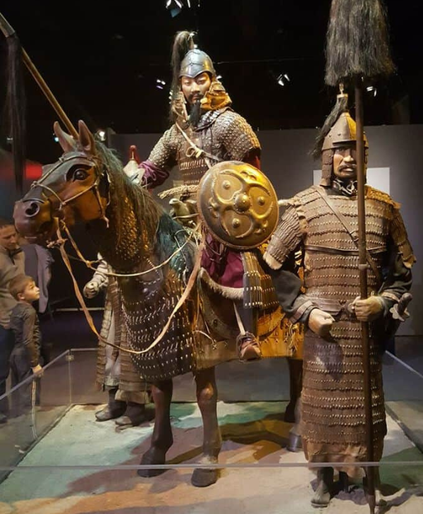 Historical chainmail, helmets, chairs, and swords from the Mongol era, showcasing detailed craftsmanship.