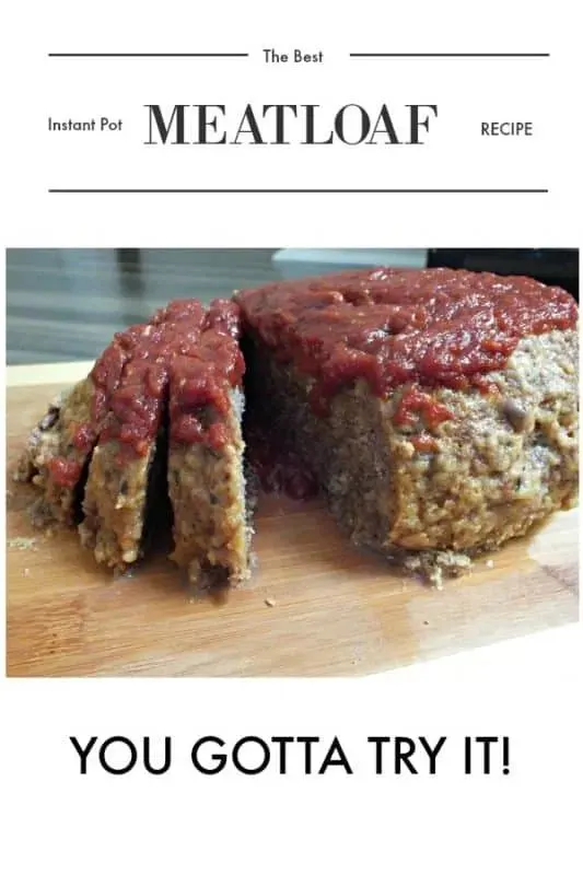 Sliced Instant Pot meatloaf on a wooden cutting board, topped with a thick tomato glaze.