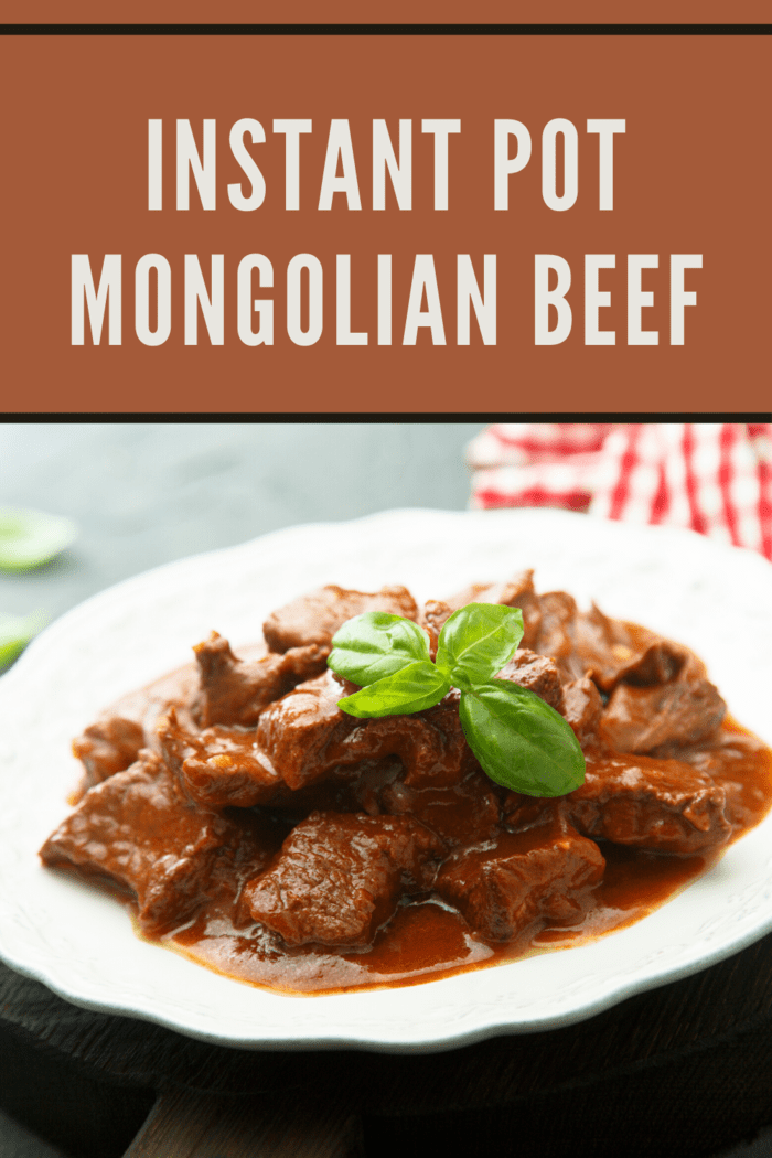 Instant Pot Mongolian Beef in a bowl with savory sauce and green basil garnish