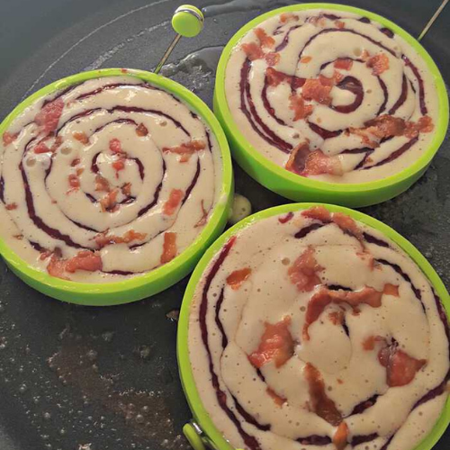 pancake in rings with raspberry jam and bacon bits