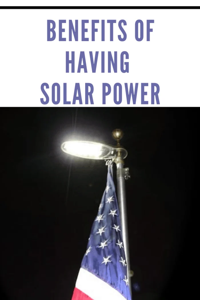 solar light shining on American Flag in night with black sky
