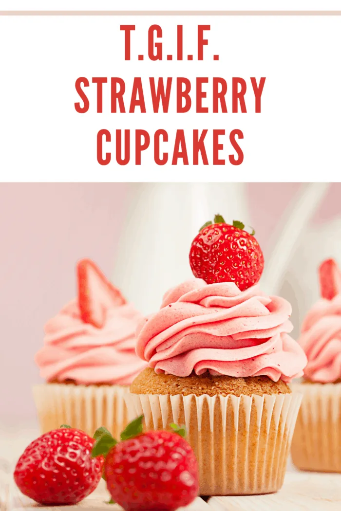 T.G.I.F. Strawberry Cupcakes garnished with fresh, whole strawberries