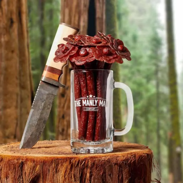 manlyman beef flowers mug on a log with knife.