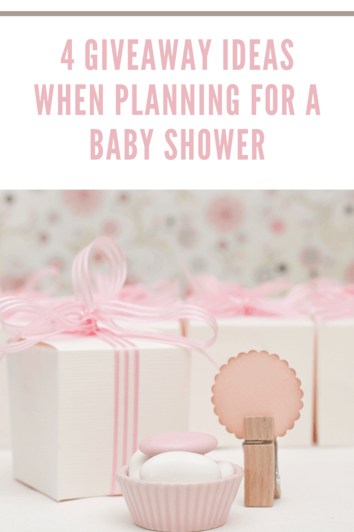 white boxes with dainty pink ribbons as a baby shower giveaway